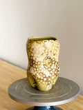 Organic cup with voluptuous form and tactile surface details